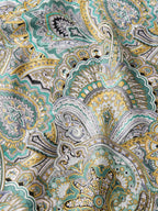 Close-up of sage, teal, gold, and cream paisley wild rag pattern with detailed rosettes