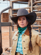Emerald jacquard wild rag worn as a neck scarf under a cowboy hat