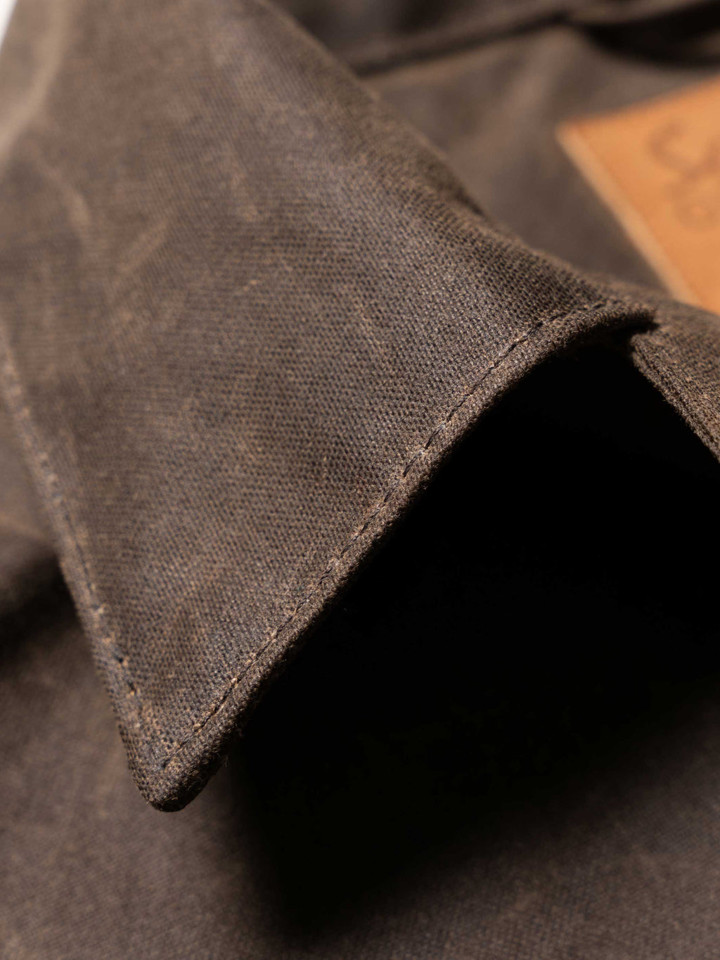 Mesquite brush jacket fabric and collar edge, dark brown woven texture