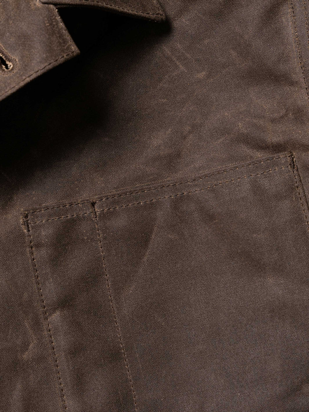 Mesquite brush jacket pocket and seam detail, dark brown with stitched panel