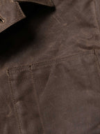 Mesquite brush jacket pocket and seam detail, dark brown with stitched panel