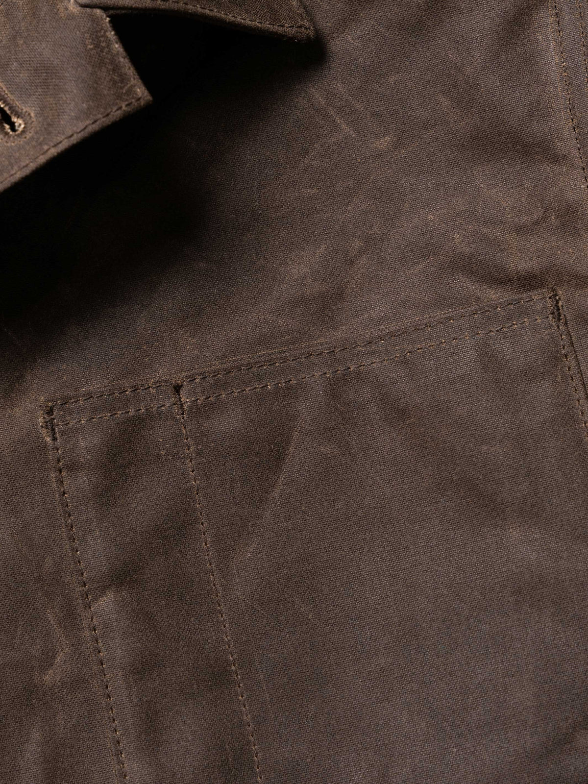 Mesquite brush jacket pocket and seam detail, dark brown with stitched panel