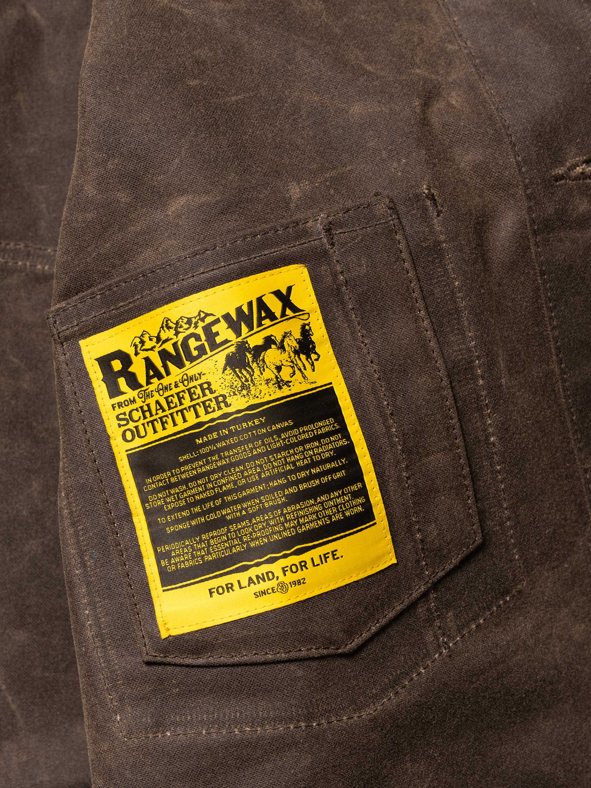 Mesquite brush jacket inner label patch, yellow RangeWax text on dark brown