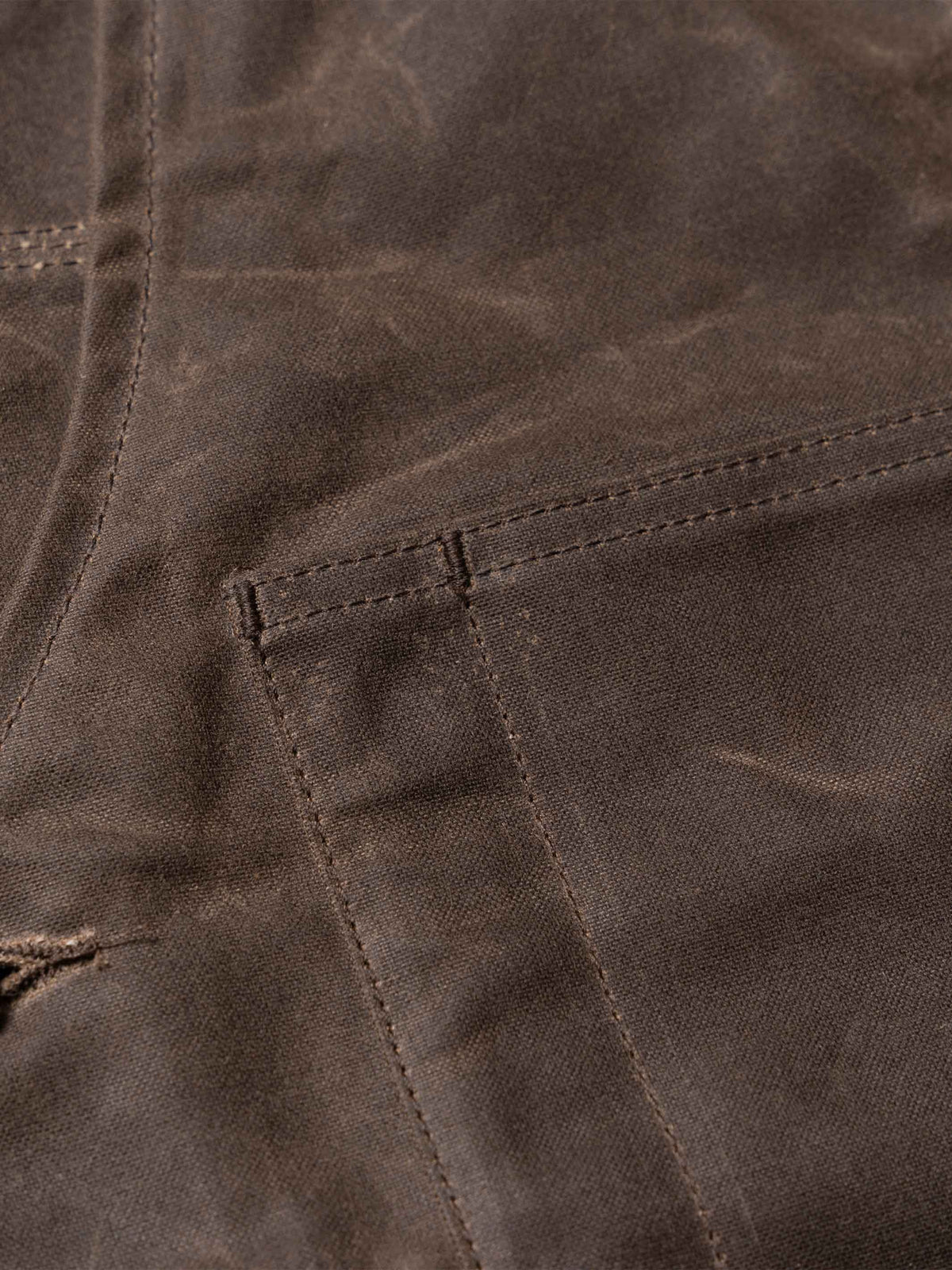 Mesquite vest pocket stitching and textured dark brown fabric detail