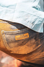 Blue denim back pocket with tan leather patch labeled Ranch Hand.