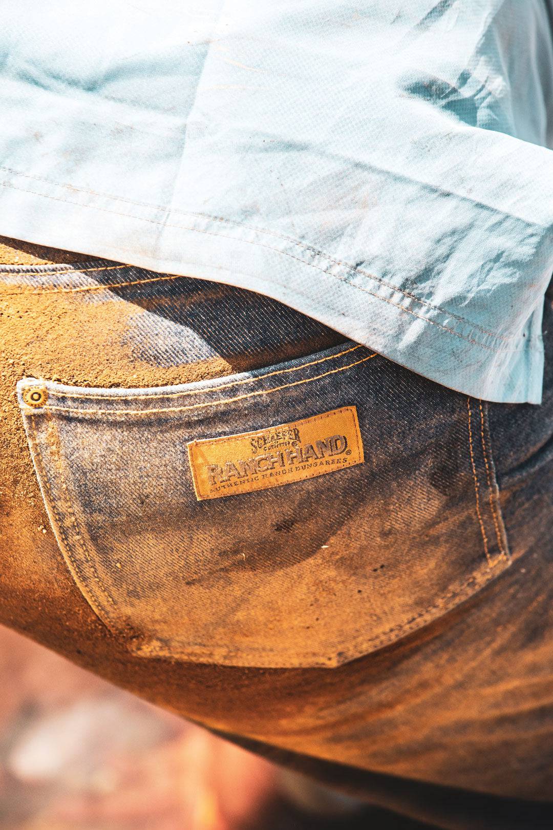 Blue denim back pocket with tan leather patch labeled Ranch Hand.